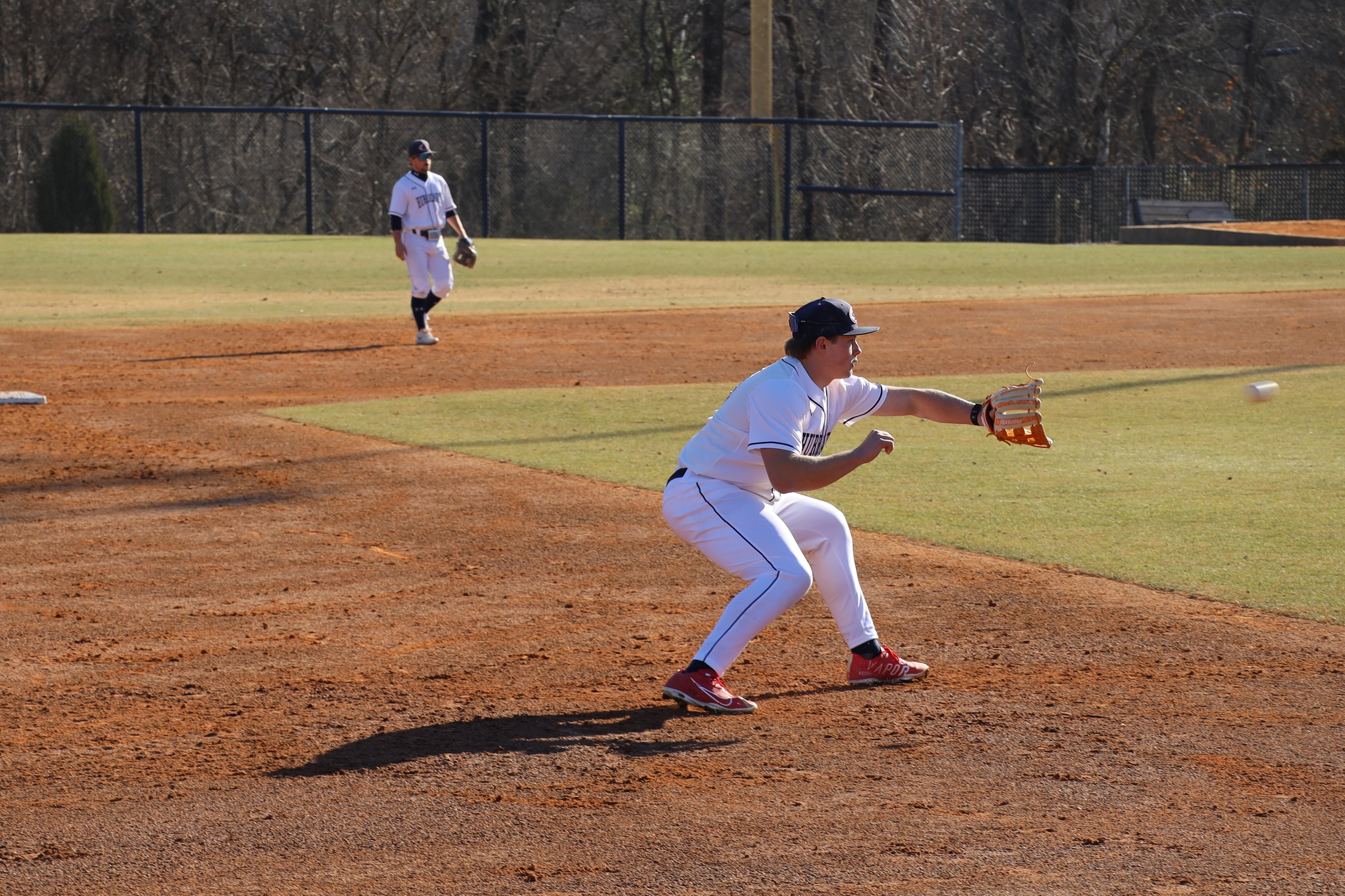 Third basemen fielding the ball.