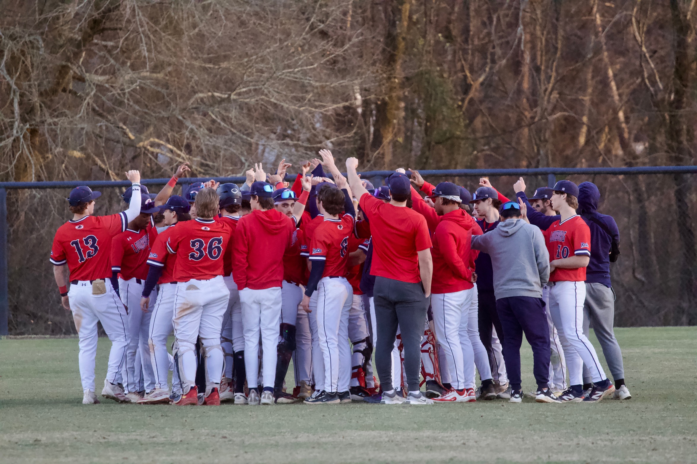 Baseball team huddle after the game.