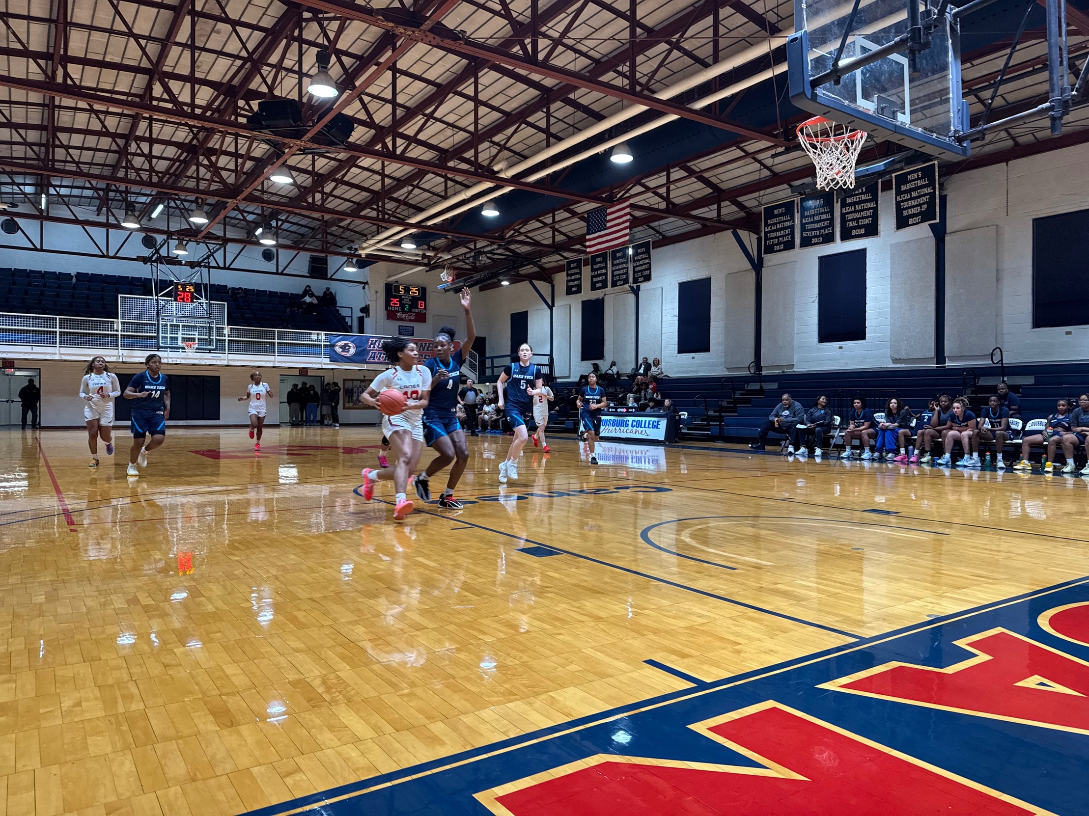 Louisburg College player drives to the hoop.